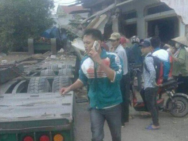 Xe đầu kéo đâm vào nhà dân, tài xế và phụ xe mắc kẹt trong cabin