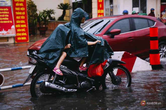 Phụ huynh ẵm bồng con nhỏ, bì bõm lội nước về nhà sau cơn mưa lớn ở Sài Gòn Phụ huynh ẵm bồng con nhỏ, bì bõm lội nước về nhà sau cơn mưa lớn ở Sài Gòn