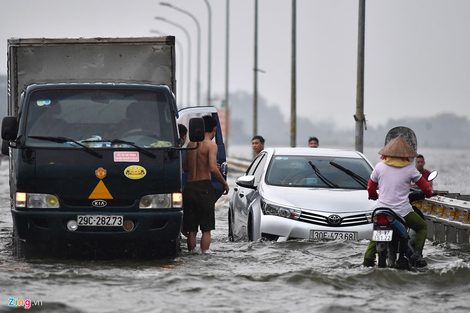Trai tráng trêu đùa xe cộ đang cố băng qua đường ngập nước