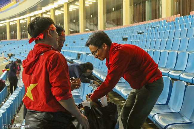 Phó thủ tướng Vũ Đức Đam nán lại cùng một số CĐV dọn rác trên sân Mỹ Đình sau chiến thắng của ĐT Việt Nam