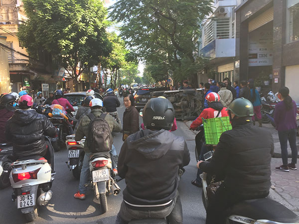 Góc đoàn kết: Người dân cùng nhau giải cứu chiếc ô tô gặp nạn lật ngang trên vỉa hè Hà Nộ