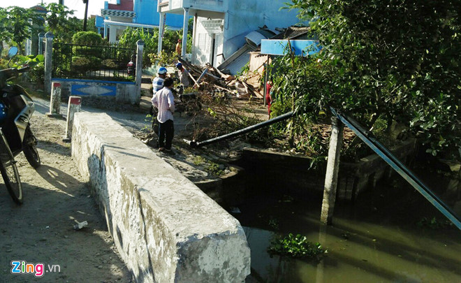 Xe tải bay lên nóc nhà ven đường