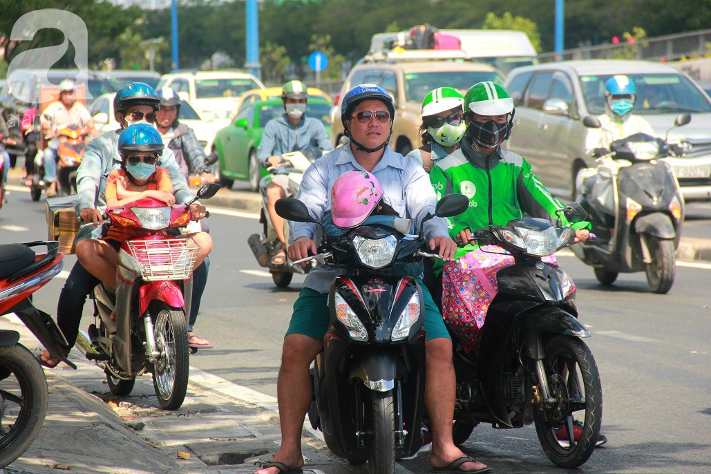 Sài Gòn nắng kinh hoàng sau Tết, người lớn trùm kín như Ninja, trẻ em mệt mỏi gục trên xe