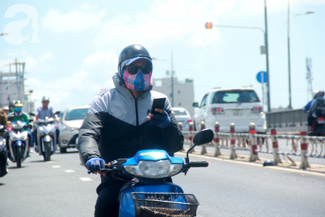 Sài Gòn nắng kinh hoàng sau Tết, người lớn trùm kín như Ninja, trẻ em mệt mỏi gục trên xe
