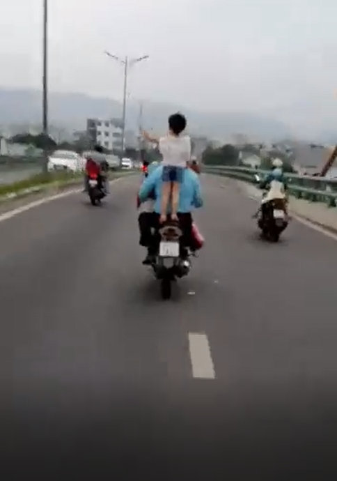 Clip: Để bé gái đứng lên yên chơi đùa lúc xe máy đang phóng vù vù, người đàn ông nhận cả đống gạch đá