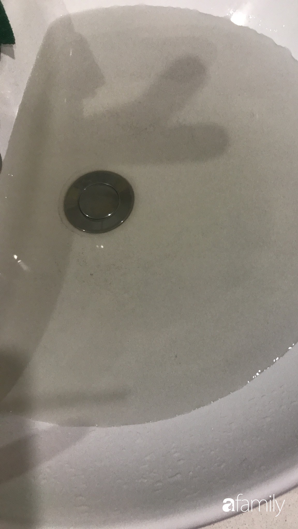 Nước xả từ vòi xuống chậu rửa mặt liên tục trong tình trạng cặn đen, vàng đục.