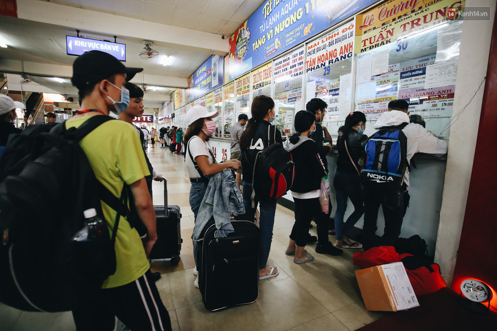 Hành khách xếp hàng dài chờ nhận vé lên xe.