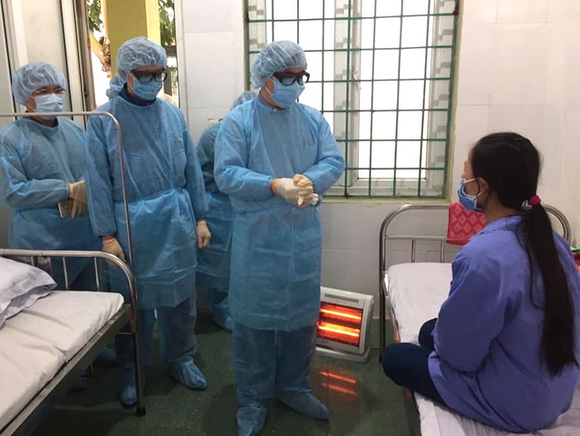 PGS.TS Lương Ngọc Khuê, Cục trưởng Cục Quản lý khám chữa bệnh (Bộ Y tế) động viên một bệnh nhân dương tính COVID-19 đang điều trị tại Trung tâm y tế huyện Bình Xuyên.