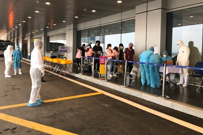 Hành khách làm thủ tục hàng không và kiểm tra y tế. Ảnh: Bình Minh