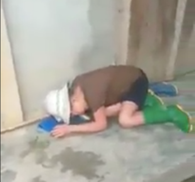 Bà cụ nằm bất động tại chỗ sau khi bị nghịch tử đánh. (Ảnh cắt từ clip).