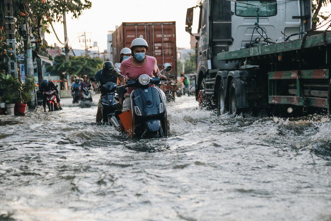 Người dân ì ạch đẩy xe trên đường ngập