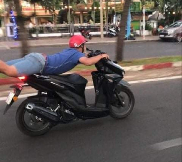 B. vừa nằm trên yên xe vừa điều khiển xe trên đường TP. Vũng Tàu (Ảnh: Cắt từ clip)