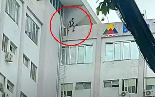 Hình ảnh thanh niên này ngồi vắt vẻo trên tầng thượng bệnh viện