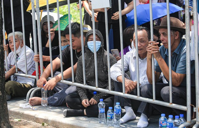 Người dân được tình nguyện viên phát nước trong thời gian chờ đợi