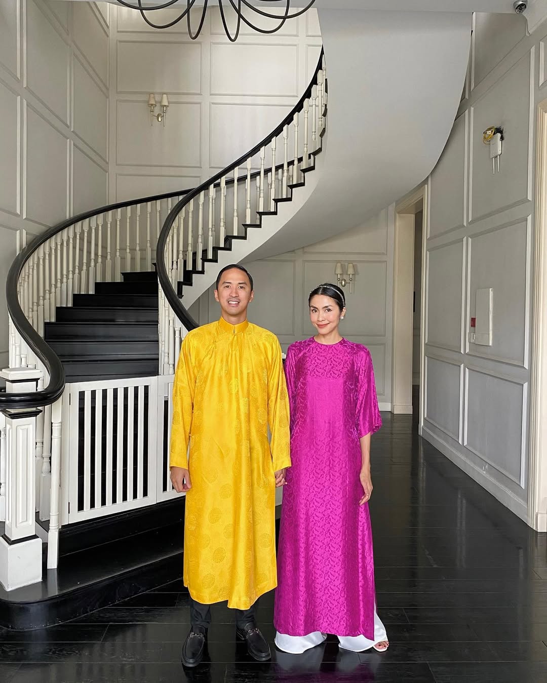 Sắc hồng đậm trong tà áo dài của Tăng Thanh Hà và sắc vàng tươi trong chiếc áo dài của Louis Nguyễn khiến cặp vợ chồng nổi bật ngày đầu năm.