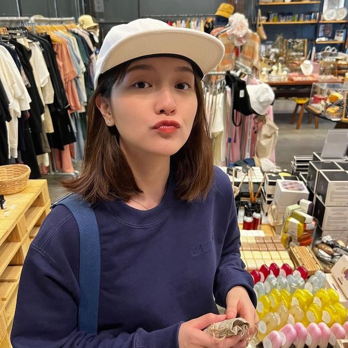 Hải Tú mặc trang phục trẻ trung, năng động và đội thêm mũ lưỡi trai màu trắng