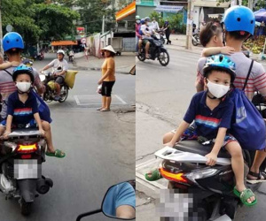 Bố chở 2 con nhỏ đi chơi, đội mũ bảo hiểm đoàng hoàng nhưng người đi đường vẫn thấy run sợ