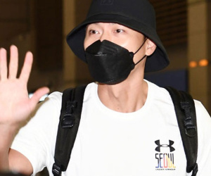Hyun Bin bịt kín khi tới sân bay, nghiêng đầu cười trước ống kính máy ảnh