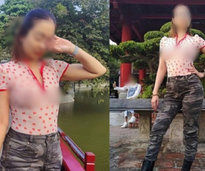 Người phụ nữ 'thả rông' đi khắp Sài Gòn cùng chồng con lại tiếp tục mặc áo xuyên thấu khoe ngực trần tạo kiểu khó hiểu trước Đền Ngọc Sơn