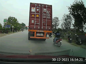 Thanh niên không đội mũ bảo hiểm bám càng xe container khiến người đi đường chán nản