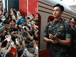 Thượng úy Lê Hoàng Hiệp được các chiến sĩ khác 'hộ tống' di chuyển ra khỏi vòng vây của đông đảo người dân tại ga Hà Nội