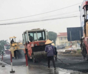 Quảng Ninh: Công nhân 'hồn nhiên' rải nhựa đường giữa trời mưa