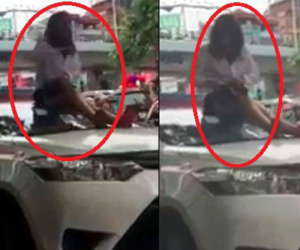 Bị CSGT dừng xe vì vượt đèn đỏ, nữ tài xế taxi trèo lên nóc xe ăn vạ