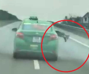 Taxi hất công an lên nóc ca pô, lao vun vút trên cao tốc