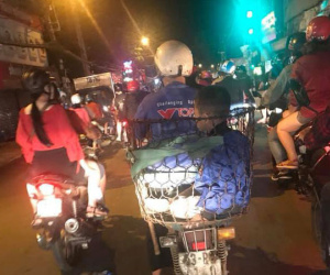 Bức ảnh cha chở 2 con đi đón năm mới trong chiếc sọt thồ hàng khiến nhiều người cảm động