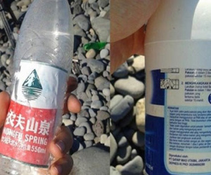 Chai nước Trung Quốc dạt gần cánh máy bay nghi của MH370