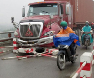 Hai người đi xe máy bị container kéo lê trên cầu Thanh Trì