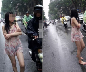 Thiếu nữ đi chân đất "tắm mưa" trên phố Hà Nội gây xôn xao