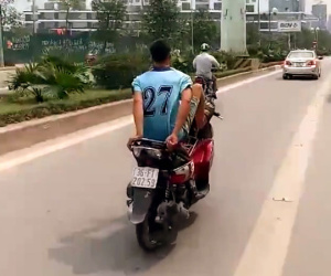 Thanh niên đi xe máy bằng chân trên làn buýt nhanh đối diện mức phạt nặng