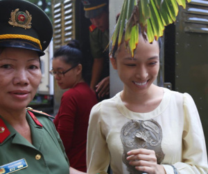 Hoa hậu Phương Nga cười tươi trước khi vào xét xử
