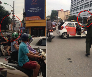 Bị nhắc nhở đi vào đường cấm, tài xế taxi trèo lên nóc xe ăn vạ