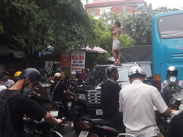 Hà Nội: Xôn xao hình ảnh cô gái không mặc áo trèo trên nóc ô tô la hét khiến người đi đường hoảng sợ