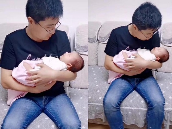 Bố bế con gái mới sinh, ánh mắt 'sắc lạnh' của con trai lớn ngồi bên cạnh gây 'bão' mạng