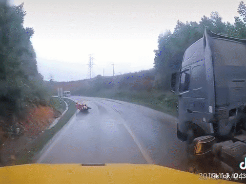 Video: Xe máy trượt ngã, lao thẳng vào đầu xe tải ở khúc cua