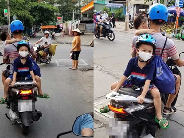 Bố chở 2 con nhỏ đi chơi, đội mũ bảo hiểm đoàng hoàng nhưng người đi đường vẫn thấy run sợ