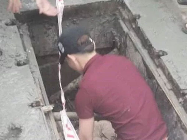Người phụ nữ đi xe máy rơi xuống hố ga ngất xỉu