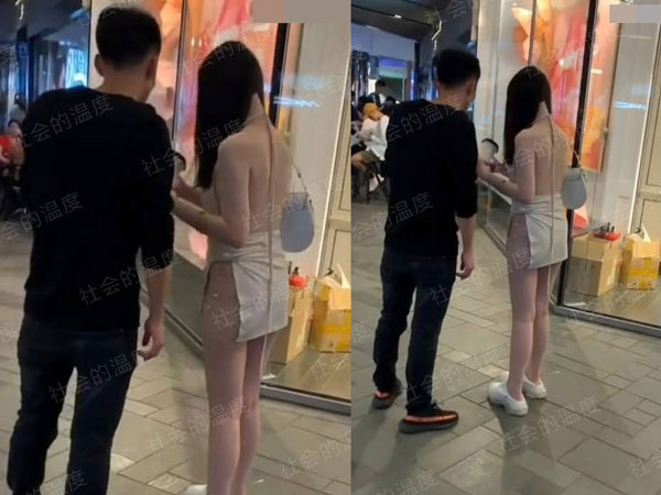 Đi TTTM cùng bạn trai, cô gái diện váy xẻ cao đến eo gây bão