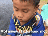 Bé trai lấm lem bùn đất ngồi bên đường thưởng thức miếng bánh cứu trợ một cách ngon lành: 'Một miếng khi đói bằng một gói khi no'