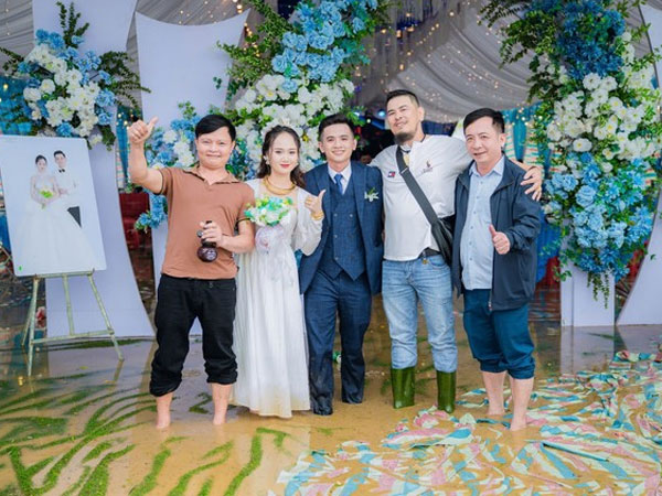 Cô dâu chú rể bì bõm lội nước tiếp khách trong nước lũ