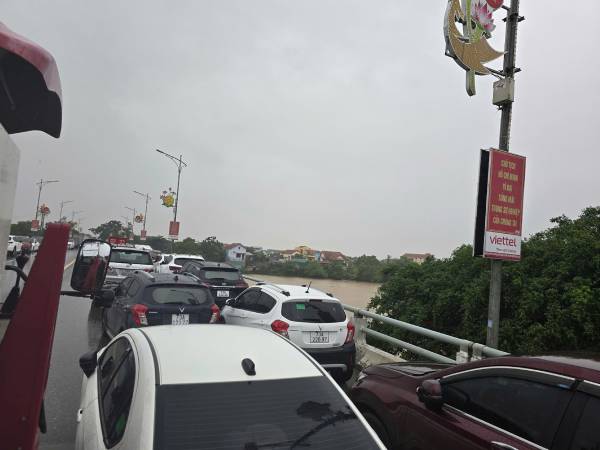 Mưa xối xả, người dân ở 'rốn lũ' Quảng Bình đưa ô tô lên cầu tránh ngập lụt