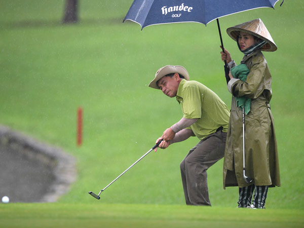 Hơn 100 CEO dự APEC đánh golf dưới mưa tầm tã ở Hội An