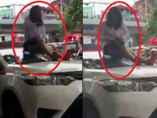 Bị CSGT dừng xe vì vượt đèn đỏ, nữ tài xế taxi trèo lên nóc xe ăn vạ