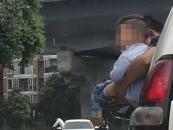 Video: Bé trai được bế ra ngoài cửa ôtô đang chạy để đi vệ sinh