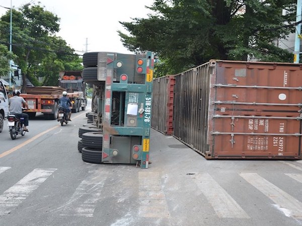 Ôm cua gấp xe container lật ngang bên đường, 2 người trọng thương