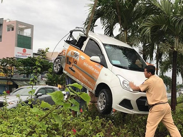 Xe tải húc văng ô tô lên dải phân cách đường Phạm Văn Đồng