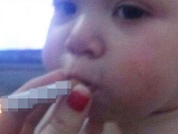 Dân mạng phẫn nộ trước màn đùa cợt của người lớn cho bé trai thử hút thuốc lá
